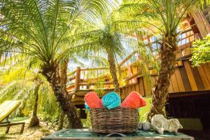 a basket of yarn sitting on a table with palm trees at Villa Nicolle - Bahia - Praia do Espelho in Praia do Espelho