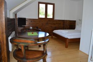 a room with a table and chairs and a bed at B&B Javorovača in Žabljak