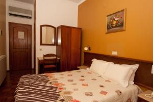 Postel nebo postele na pokoji v ubytování Hotel Leiriense