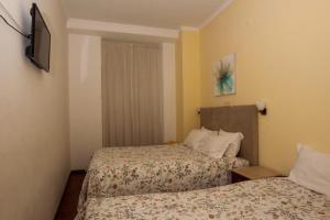 Postel nebo postele na pokoji v ubytování Hotel Leiriense