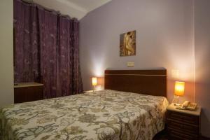 Postel nebo postele na pokoji v ubytování Hotel Leiriense