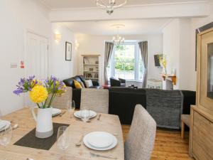 a living room with a table and a couch at Ty Ardwyn in Criccieth
