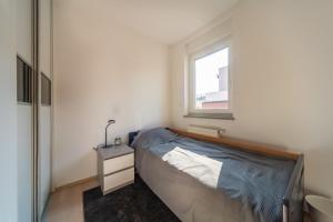 a small bedroom with a bed and a window at SUPER PetrovA Apartment in Zagreb