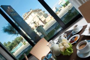 a table with a cup of coffee next to a window at Park Hotel Kursaal in Misano Adriatico