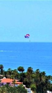a kite flying in the sky over the ocean at Las Americas Panoramic Ocean Views in Playa de las Americas