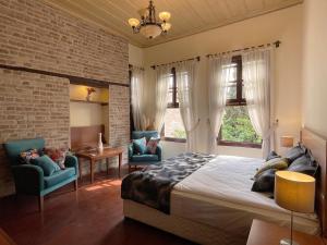 a bedroom with a large bed and two chairs at Hotel Mille Kaleiçi in Antalya