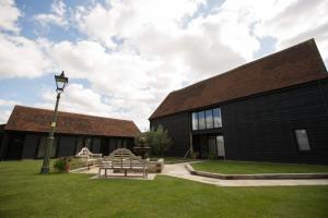 a building with benches and a street light in the grass at Channels Retreat in Chelmsford