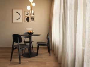 ein Esszimmer mit einem Tisch und zwei Stühlen in der Unterkunft Townhouse Apartments Maastricht in Maastricht + 28 Fotos