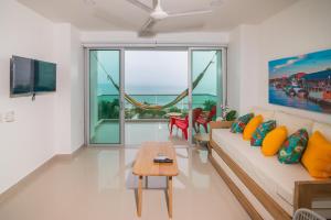 ein Wohnzimmer mit Sofa und Tisch in der Unterkunft Magico Apartamento Frente al Mar 3 Habitaciones AR44 in Coveñas