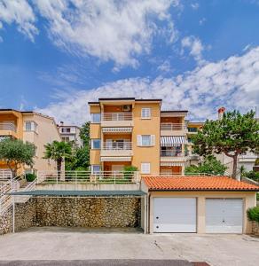 a large apartment building with two garage doors at Seaview Apartment Bojan Rabac in Rabac