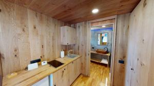 a kitchen with wood paneled walls and a sink at Căsuța de sub cireș in Piatra Neamţ +29 photos