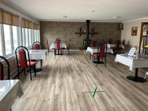 a dining room with tables and red chairs at Haven Inn in St. Anthony