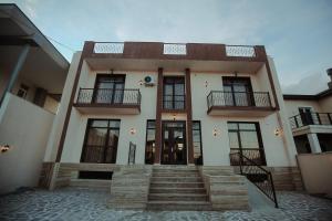 a house with a staircase in front of it at Tbilisi Sea Hotel in Tbilisi City
