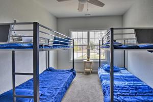 two bunk beds in a room with a window at Spacious Home Less Than 1 Mi to Kiptopeke State Park! in Kiptopeke +23 photos