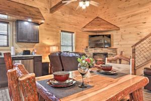 a kitchen and dining room with a table in a cabin at Pigeon Forge Cabin with Hot Tub 1 Mi to Parkway in Pigeon Forge +19 photos