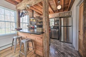 a kitchen with a counter and a refrigerator at Charming Cottage with Yard - 2 Mi to Tinker St! in Woodstock