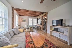 a living room with a couch and a table at Charming Cottage with Yard - 2 Mi to Tinker St! in Woodstock