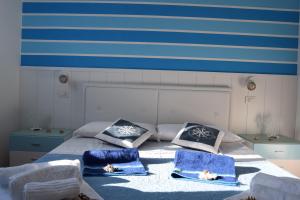 Un dormitorio con una cama con toallas azules. en IL MARE DI OLBIA Holiday Apartment, en Olbia