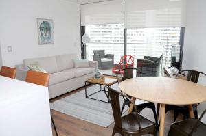 a living room with a couch and a table at Apartment - Kennedy - Parque Arauco in Santiago