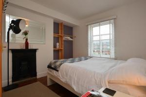 a bedroom with a large bed and a fireplace at InTown - 60 second walk 2 Minster! in York