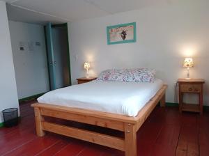 1 cama en una habitación con 2 lámparas en 2 mesas en Bidea Backpackers Hostel, en Filandia