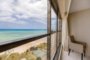 a view from a balcony of a beach with a view of the ocean at Transamerica Prestige - Beach Class International (Boa Viagem) in Recife