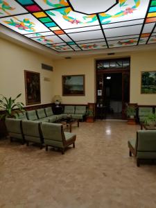 a living room with a colorful ceiling and couches at Hotel Antico Borgo in Riolo Terme