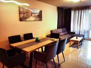 a living room with a table and a couch at Harmony hills view apartments in Rogachevo