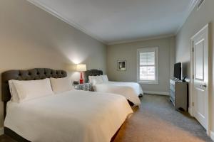 a bedroom with two beds and a flat screen tv at The Mantissa Hotel in Hartsville