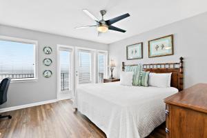 a bedroom with a bed and a ceiling fan at Costa Del Sol in Destin
