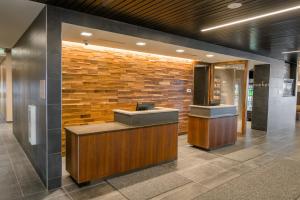 a lobby with a stone wall and a reception desk at Courtyard by Marriott Fargo in Fargo