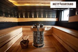 a inside of a sauna with a sink in it at Metsäkartano in Kannus