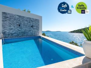 a swimming pool with a view of the ocean at Villa Sine in Sevid