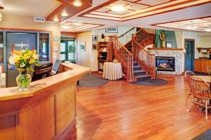 a kitchen with wooden floors and wooden cabinets at Coastal Inn Halifax - Bayers Lake in Halifax