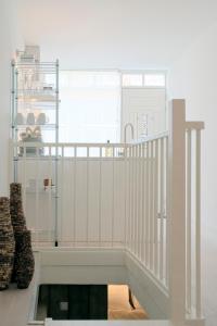a white staircase in a room with two boots at Jordaanapartment in Amsterdam