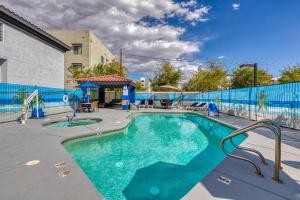 a swimming pool with a blue fence around it at The Azure Hotel in Mesa