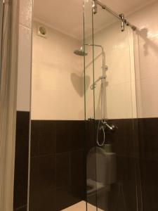 a shower with a glass door in a bathroom at Guest house Forest in Pyatigorsk