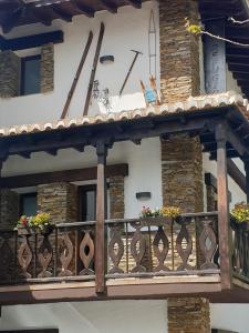a balcony of a house with flowers on it at El refugio in Pinos Genil