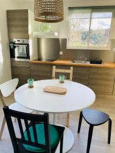 a white table and chairs in a kitchen at Charmant Studio proche Lac et Forêt in Carcassonne