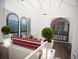 a balcony with a red bench and a view of the city at Napolart in Naples