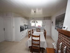 a kitchen with a table and chairs in a room at Serene Holiday Home in Peer in Peer