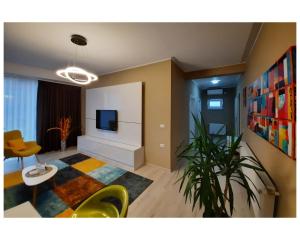 a living room with a tv and a table and chairs at N.D Global Alba Iulia in Alba Iulia