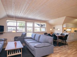 a living room with a couch and a table at Seaside Charm in Ristinge-By Traum in Humble