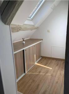 an attic room with a skylight and a wooden floor at Gite la Bancloque in Compiègne