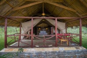 a large tent with red chairs in it at Sentrim Mara Lodge in Ololaimutiek