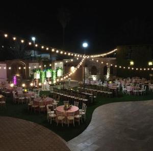 an outdoor event with tables and chairs and lights at Hotel Andares de Kino by Rotamundos in Magdalena de Kino