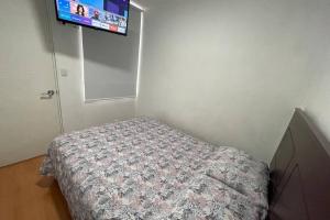 a bedroom with a bed and a flat screen tv at 6 - Departamento de 2 dormitorios en area turistica de Miraflores in Lima