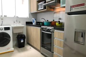 a kitchen with a stove and a washing machine at 6 - Departamento de 2 dormitorios en area turistica de Miraflores in Lima