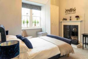 a bedroom with a large bed and a fireplace at Spacious city centre apartment full of character in Inverness