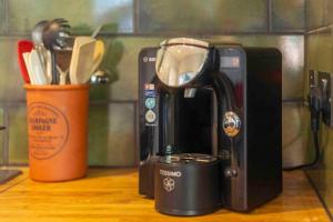 a coffee maker sitting on top of a counter at Spacious city centre apartment full of character in Inverness +14 photos